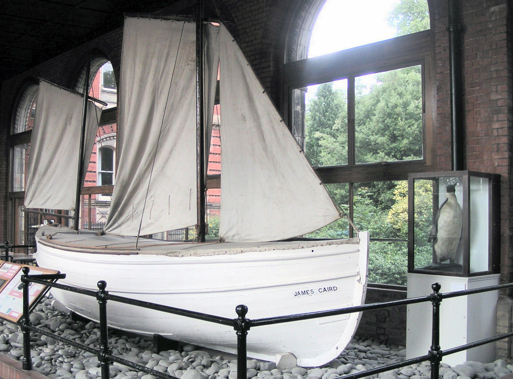 Shackleton's boat, the James Caird at Dulwich college London.Postcard of the Yelcho