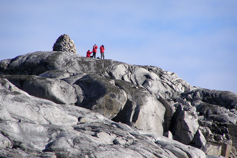 Rock cairn at Port Charcot, Booth Island, with wooden pillar and plaque inscribed with the names of the first French expedition led by Jean-Baptiste E. A. Charcot which wintered here in 1904 aboard Le Francais.