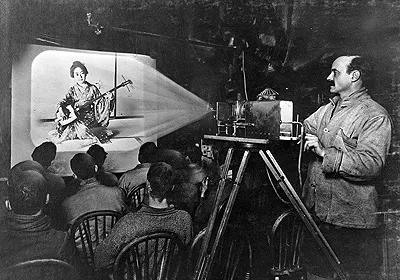 Herbert Ponting showing slides during his lecture on Japan